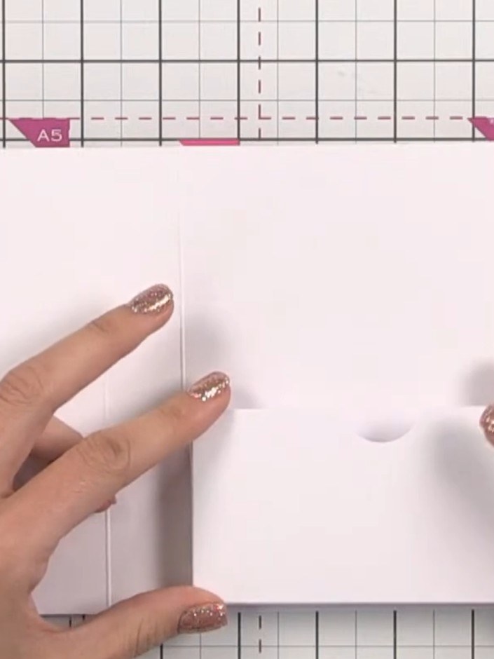 Step 13: Apply adhesive to the second pocket piece and position it on the opposite side of the book base, aligning it c