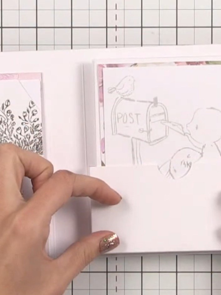 Step 14: Decorate the front cover of your book with patterned paper and stamped images. You can use the grid on your cu