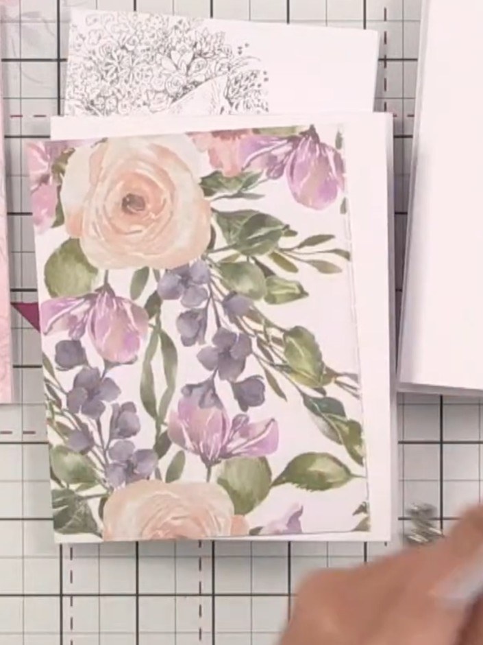 Step 9: Mount one of the stamped bunny images onto a patterned paper layer using adhesive. Attach the mounted image to