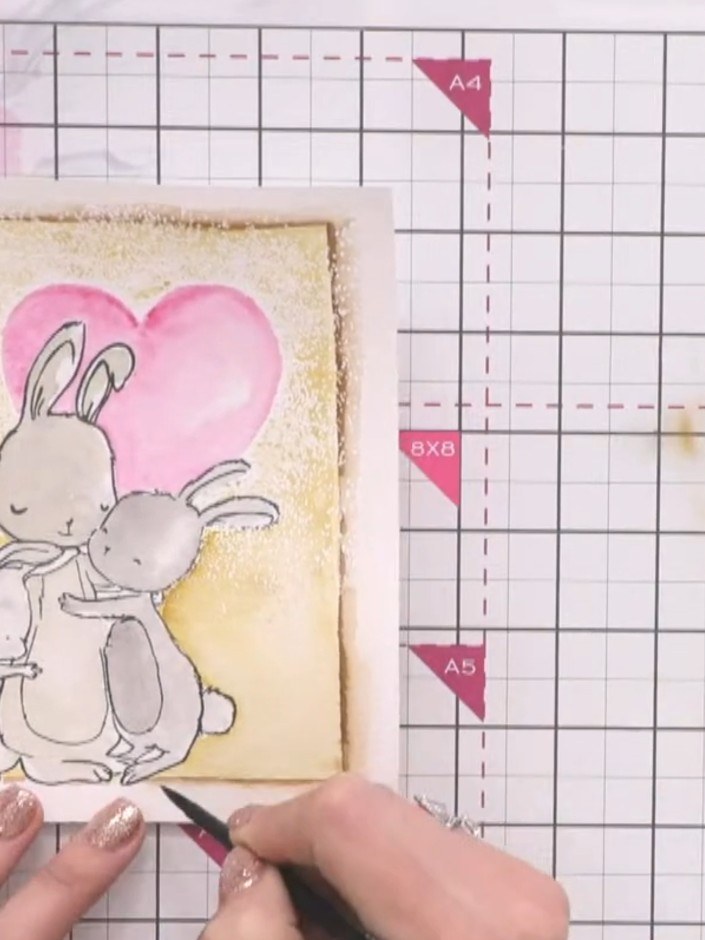 Step 12: Add a halo effect around each bunny by outlining with brown watercolour, then using a practically dry brush to