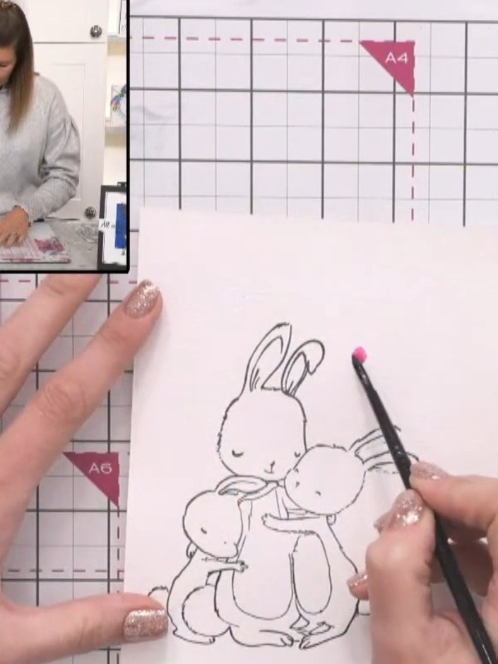 Step 7: Using a watercolour brush with pink paint, begin painting the interior details of the bunny illustration, such