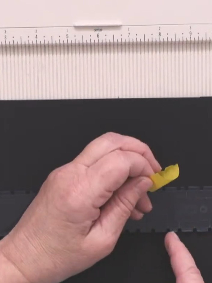Step 4: Insert the spacer piece underneath the black card to support it and prevent wobbling during scoring. Position 