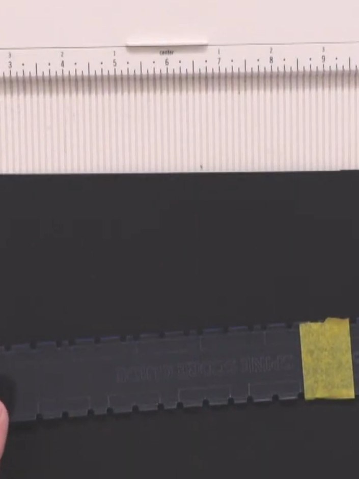 Step 5: Score along each marked line using your scoring tool, working slowly and carefully from bottom to top. Hold th