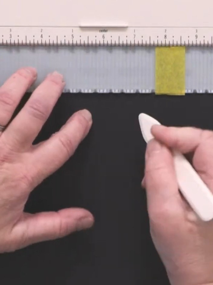 Step 6: Use your multi-purpose craft tool to burnish each score line, going back and forth along the grey scored strip