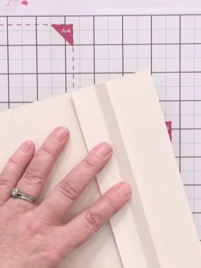 Step 8: Apply the double-sided acid-free book binding tape along the spine to join the pages together securely. Press 