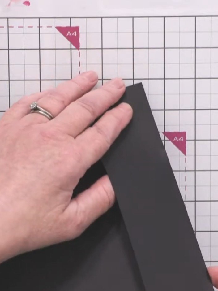 Step 3: Use the flat tip of the tool to burnish along the score line on the black card. Press firmly and work back and