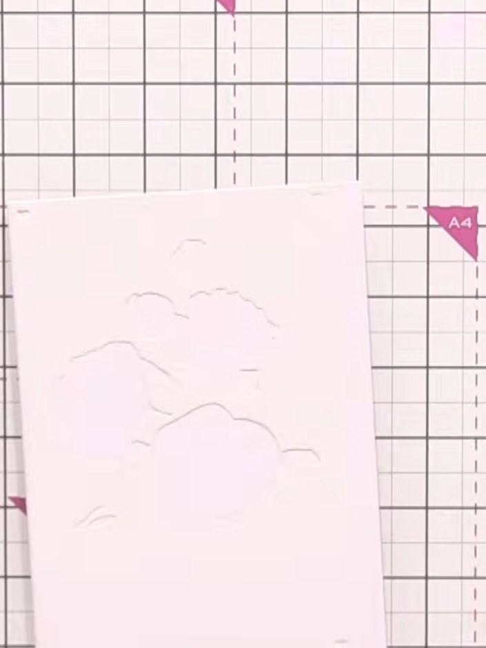 Step 2: Position stencil number one at the edge of your white card stock. Use the heart alignment guides on the stenci