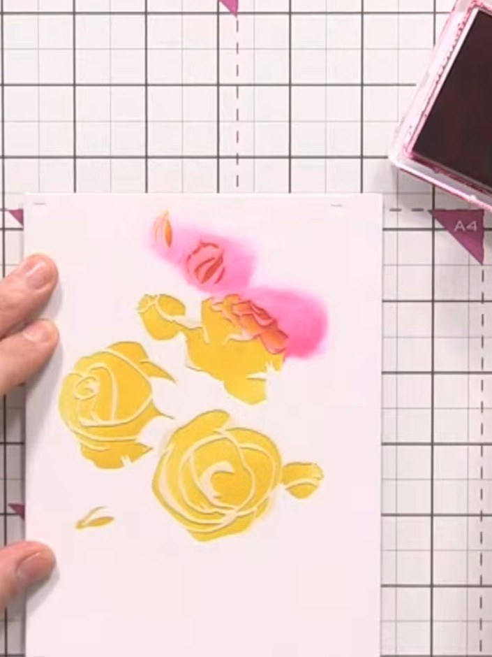 Step 4: Remove the first stencil and position the second rose stencil on top of your stamped design. Using an ink blen