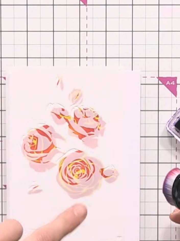Step 5: Using stencil number three from the Rose Branch set, apply purple ink over the design to add another layer of 