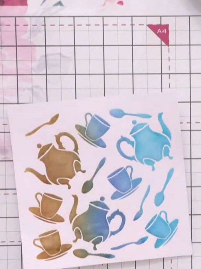 Step 6: Use a damp cloth to gently rub off the sprayed ink from the raised stencil areas, revealing the coloured ombré