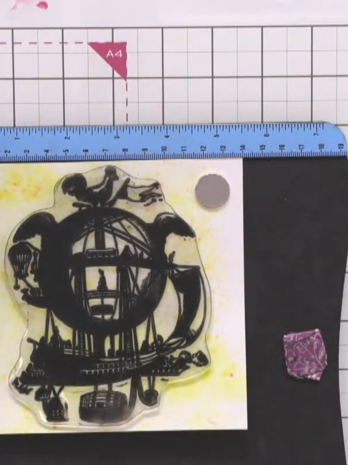 Step 4: Stamp the large steampunk airship image onto the dried yellow background using brown ink. Press firmly and eve