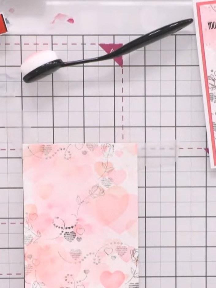 Step 7: Stamp outline roses over the top of your watercoloured design and emboss them in white for added detail and di