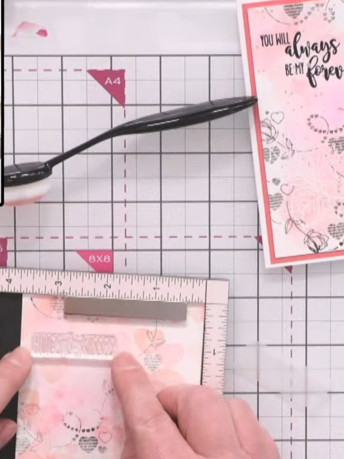 Step 8: Add a sentiment stamp to complete the card, choosing from phrases such as 'Hugs and Kisses', 'Love', 'Wedding'