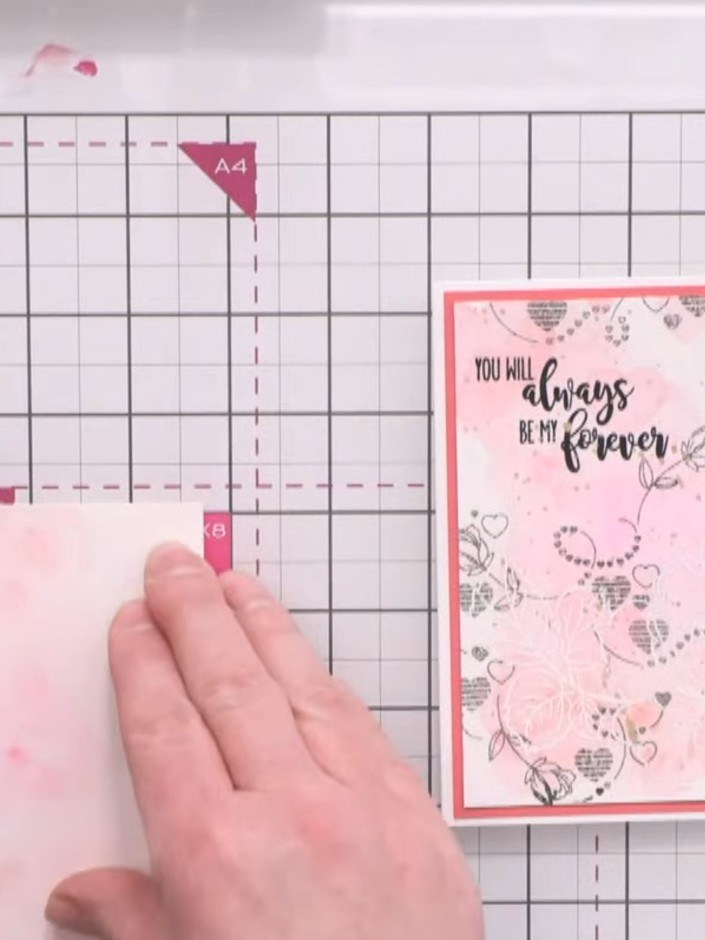 Step 1: Position the cascading heart stencil on your white card base. Using a Funky Fossil blending brush, apply light