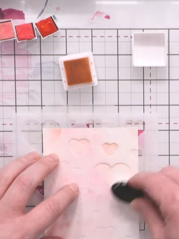 Step 2: Reposition the stencil slightly and apply a darker shade of pink ink using a blending brush to create overlapp
