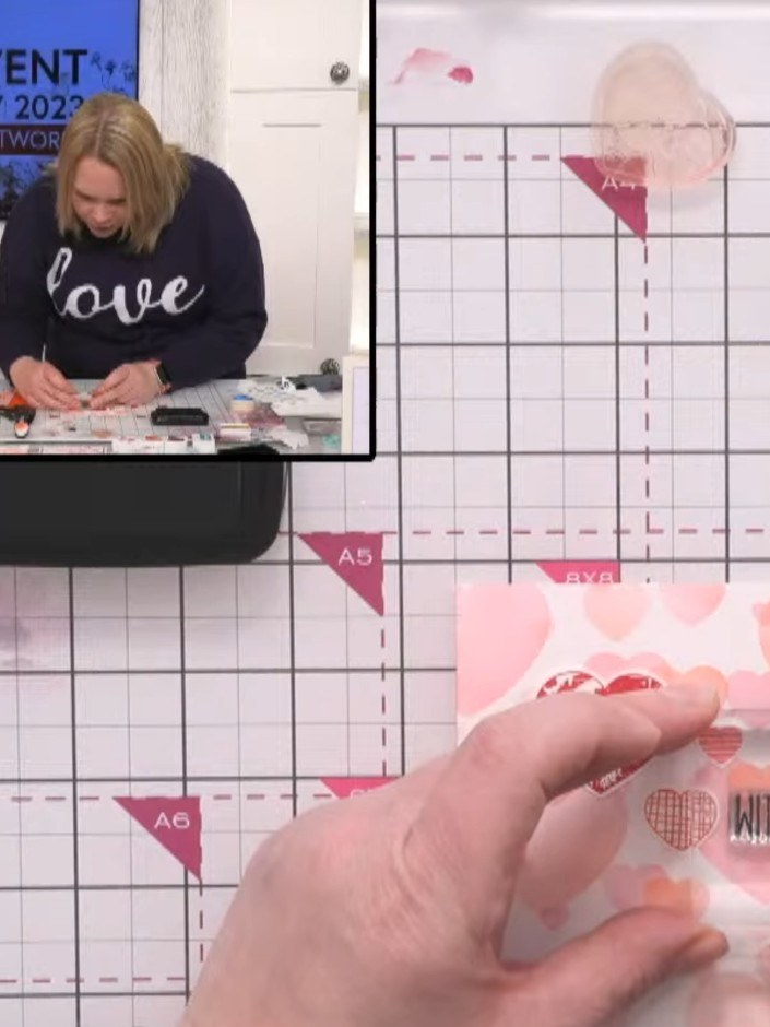 Step 5: Add small decorative hearts or additional details around the main focal heart using the smaller stamps from th