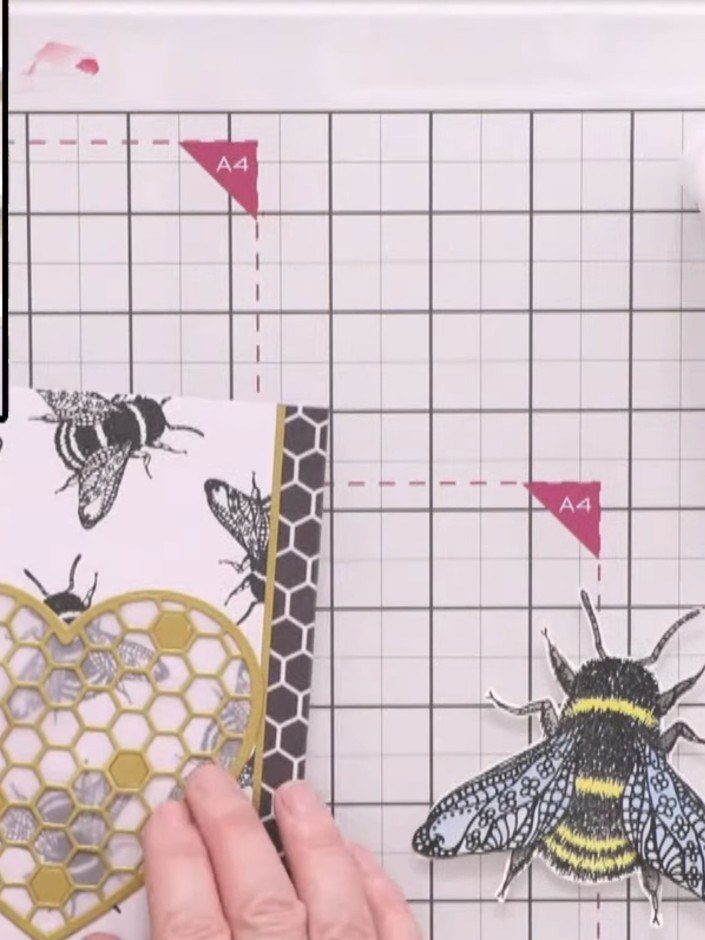 Step 7: Add gold hexagon embellishments around the honeycomb heart, positioning them decoratively to fill the space an