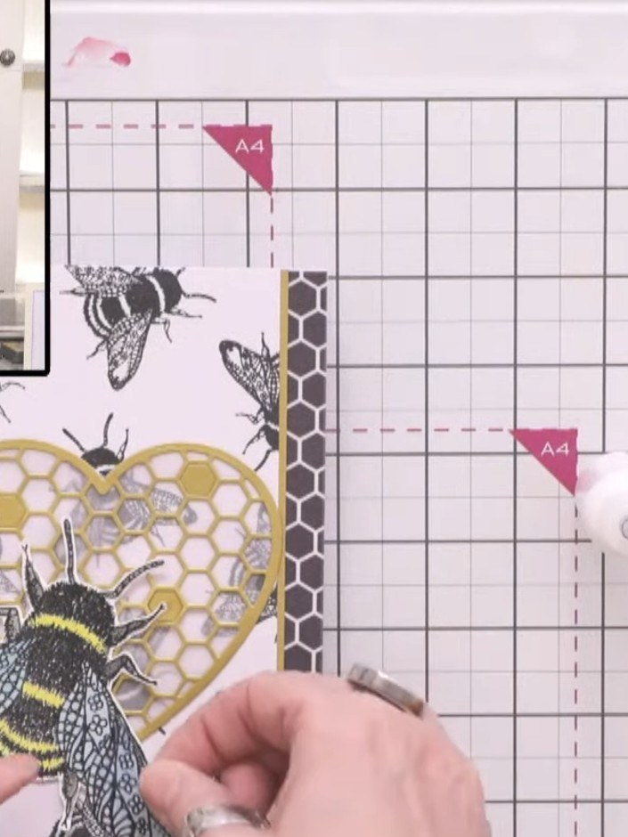 Step 8: Shape the bee wings with your fingers to add dimension. Apply glue to the back of the coloured bee and attach 