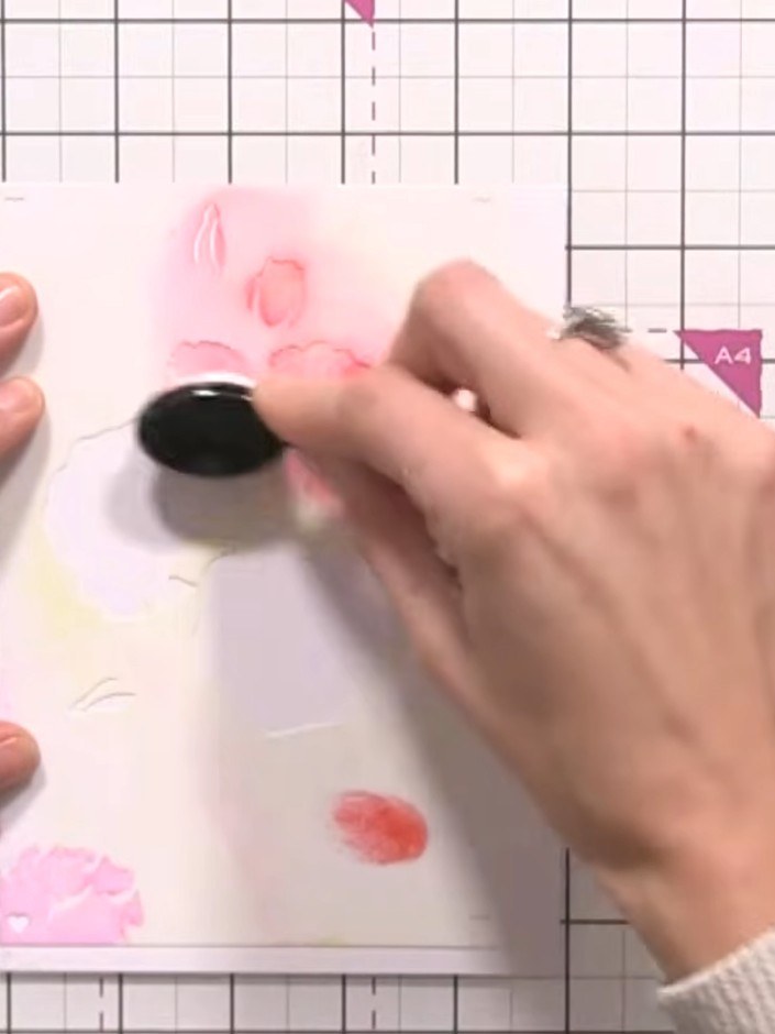 Step 3: Using the rose stencil, tap Redwood distress ink through the stencil onto your card with an ink blending tool.