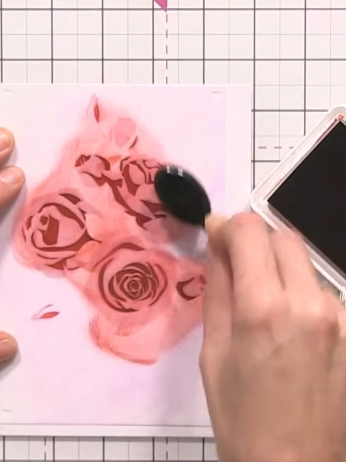 Step 5: Position stencil number three over your design and apply red ink through the stencil using a blending tool. Wh
