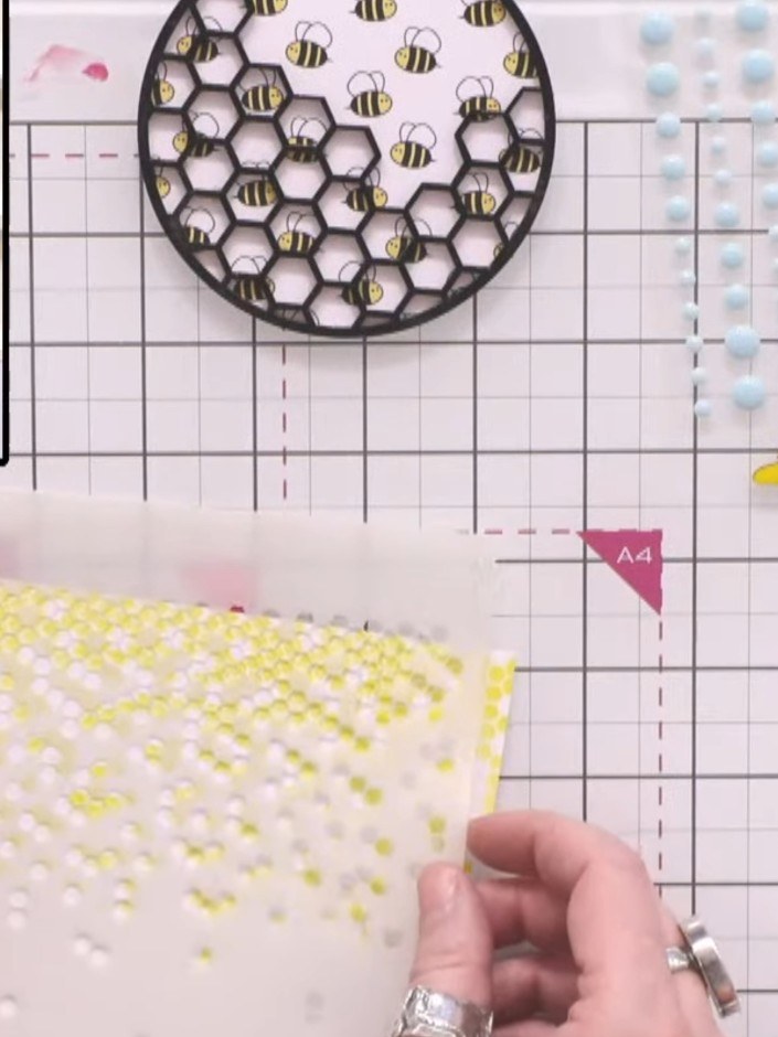 Step 4: Position the hex matrix stencil higher up on the yellow patterned panel. Apply embossing ink through the stenc