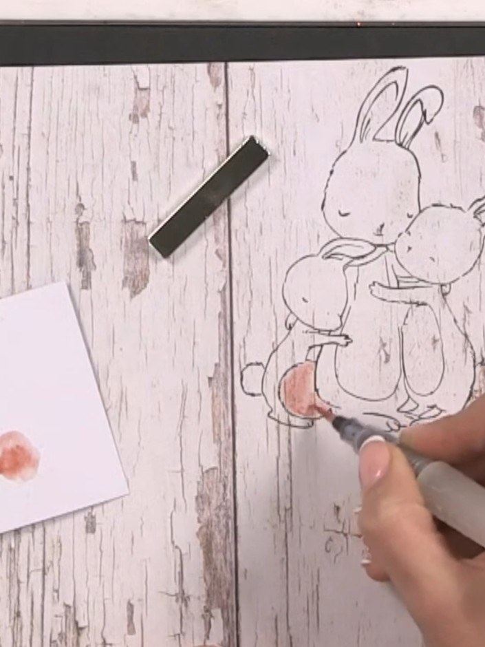 Step 2: Using a water brush and brown watercolour from your palette, add light washes of colour to the stamped bunny i