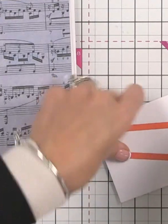 Step 7: Apply red liner tape to the back of the fussy-cut bunny panel. Fold the white card piece and burnish the fold 