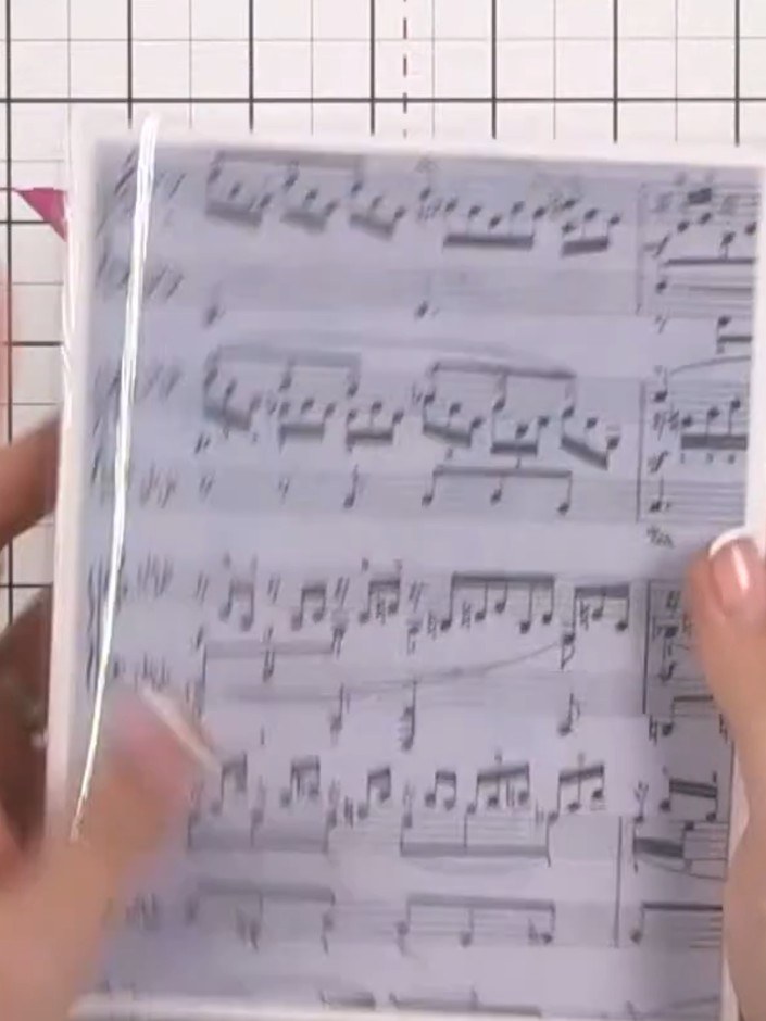 Step 8: Position the music note acetate sheet inside the card, placing it slightly higher than centre. Press down firm