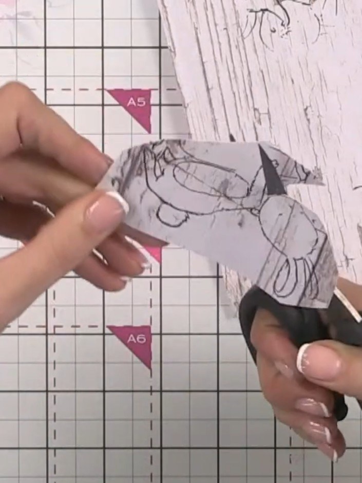 Step 11: Position and glue the fussy-cut bunny images onto and between the hill layers. Arrange them so some bunnies ap