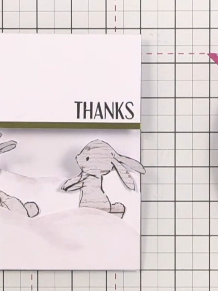 Step 13: Embellish the hills and bunnies with sequins and sparkles to complete the layered scene card.