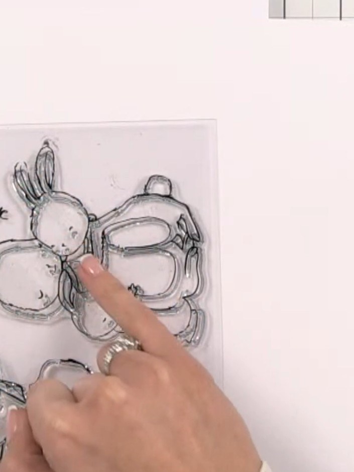 Step 8: Stamp the bunny characters onto patterned textured paper using black ink. Position the stamp carefully and pre
