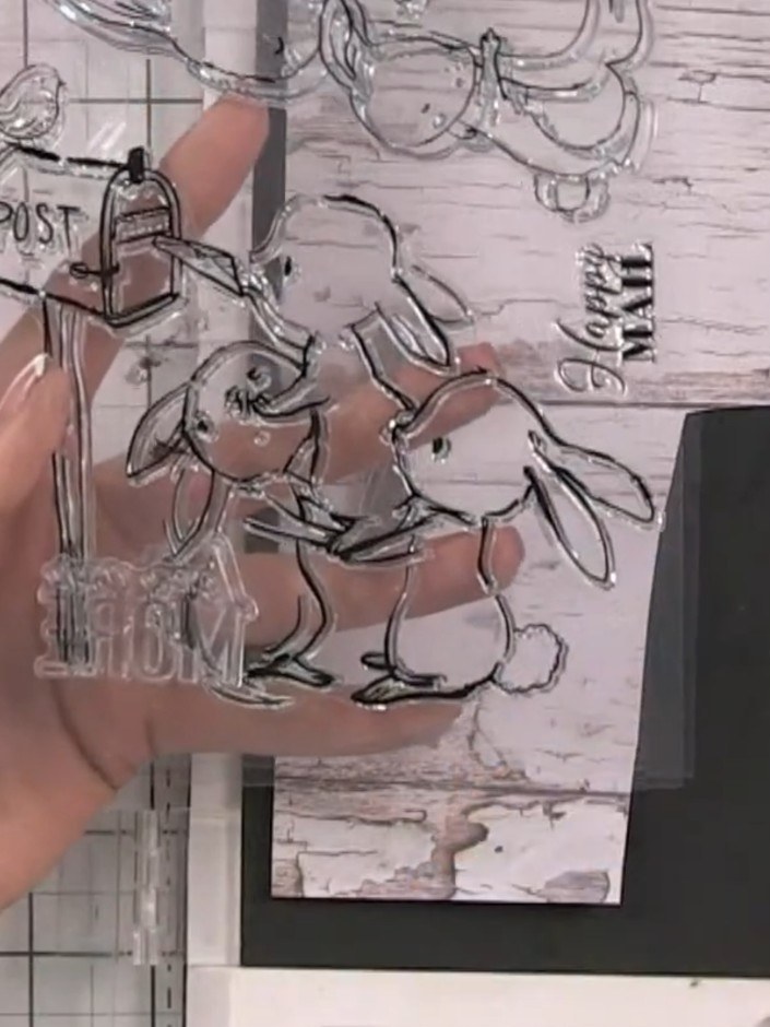 Step 9: Fussy cut the stamped bunny images from the paper using scissors, carefully cutting around the outlines of the