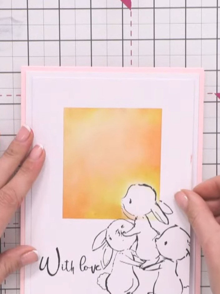 Step 15: Adhere the white matte layer with the bunny image and sentiment onto a pink card base to complete your card.