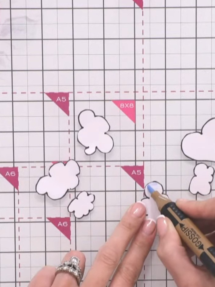 Step 3: Using a grey alcohol marker, outline the inside edge of each cloud shape to add dimension and prevent them loo