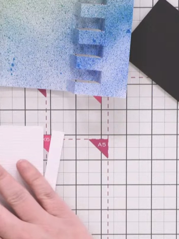 Step 10: Cut decorative panels from your chosen patterned paper measuring 6½ by 2½ inches for the centre panel and ½ by