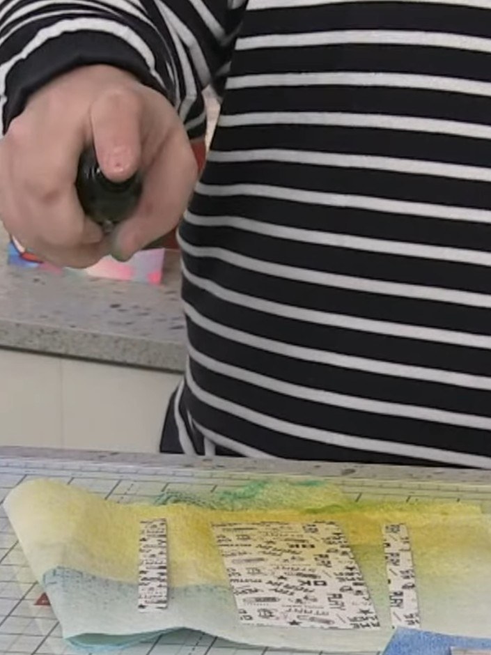 Step 12: Spray the stamped panels with yellow Izink spray on the lower section and blue Izink spray on the upper sectio