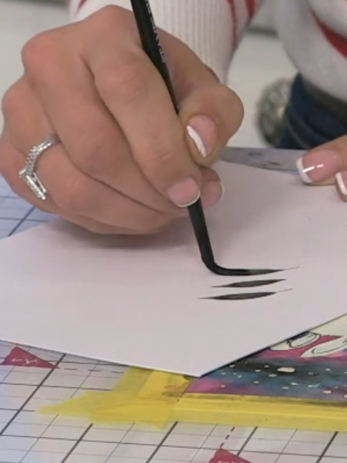 Step 12: Using a medium paintbrush and black watercolour, freehand paint silhouette foliage around the bunnies. Use a t