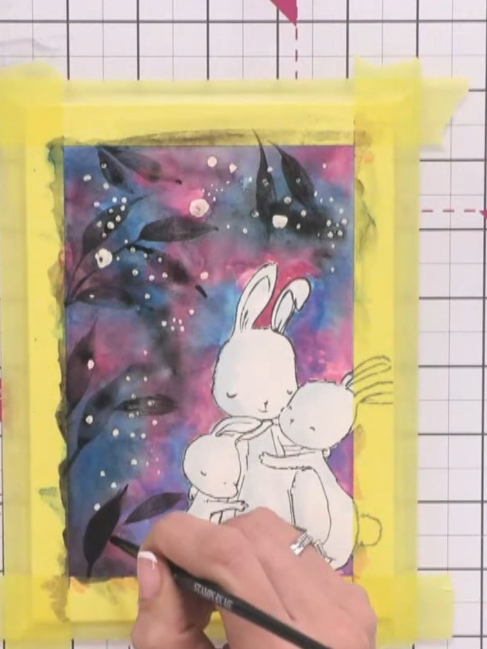 Step 13: Go over the silhouette lines of the bunnies a second time with your brush to darken them and make them more de