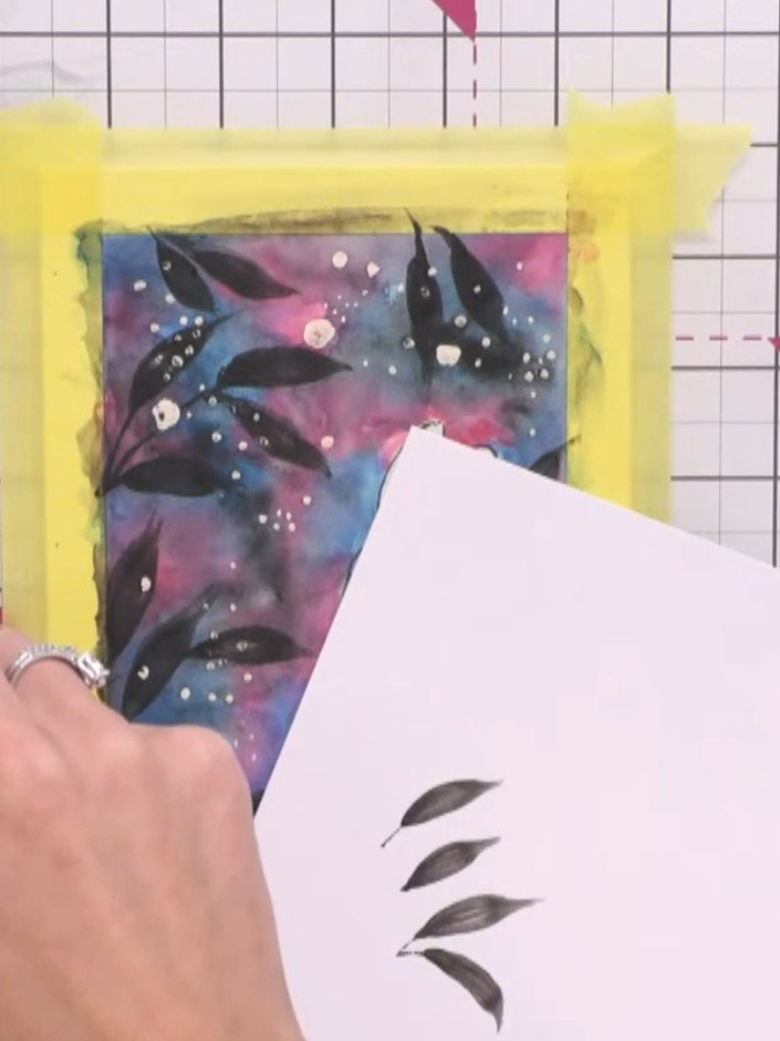 Step 15: Gently rub away the masking fluid with your finger to reveal the white card underneath, creating snowy spots o