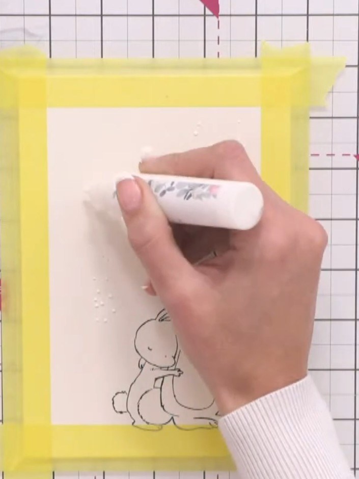 Step 4: Apply masking fluid in random spots and blobs across the card to create a snowy effect, varying the size of th
