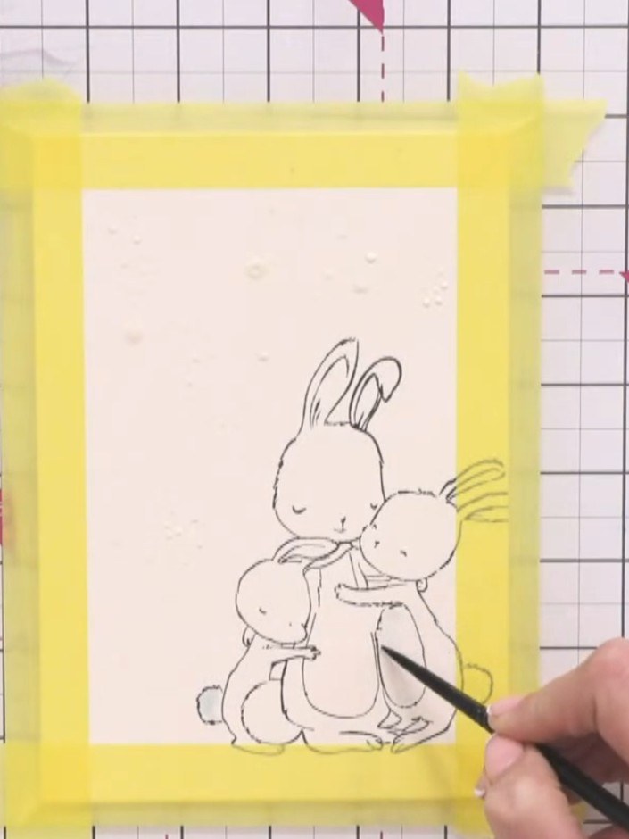 Step 6: Using a very pale blue watercolour wash on your paintbrush, add subtle colour accents to the bunnies' tummies 