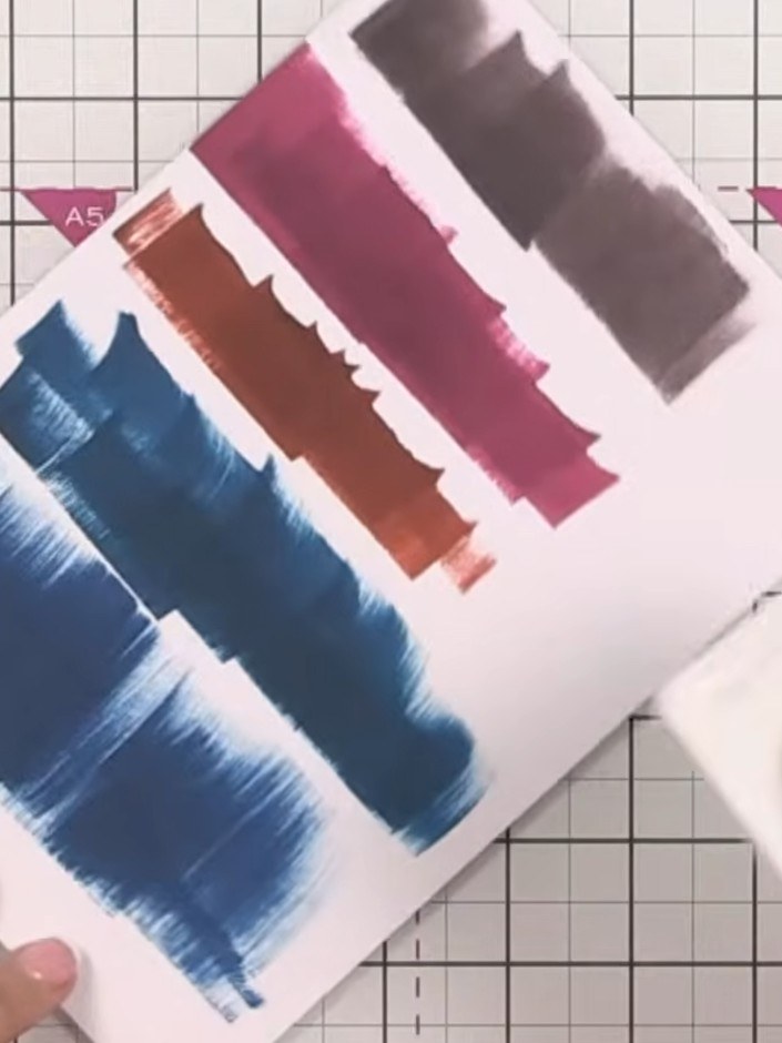 Step 2: Allow the ink to dry slightly so the colours begin to lighten naturally. The blue, brown, pink and black ink s