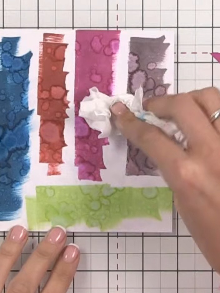 Step 6: Gently dab the watercoloured paper with tissue to remove excess water and help blend the colours together for 