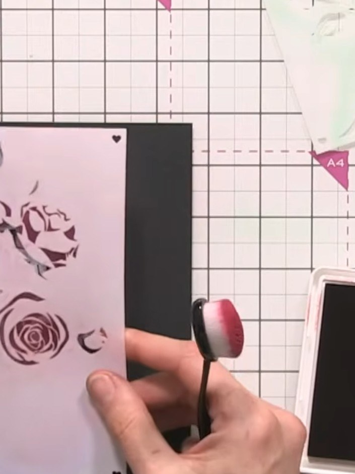 Step 10: Position the rose stencil (number three) over your card and ink through with the red ink pad using a blending 