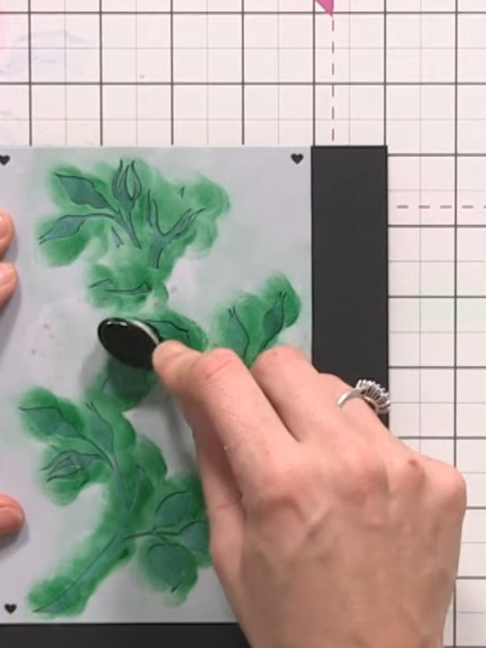 Step 11: Position stencil number four (the leaves) over your design and ink through with a green ink pad. Tap gently at
