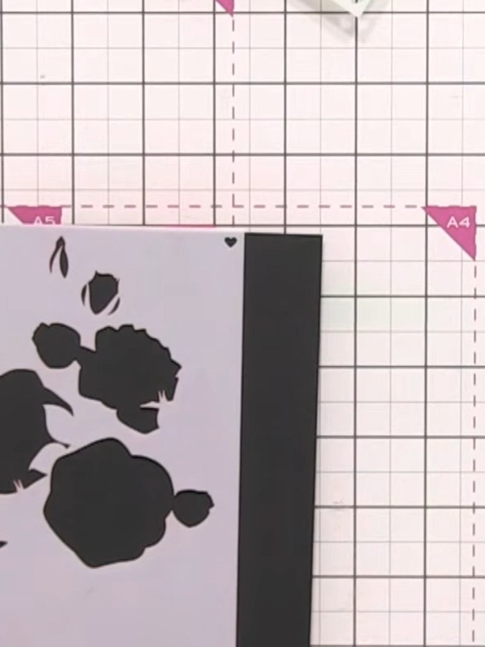 Step 3: Using the white ink pad, ink through the rose branch stencil to cover the entire stencil area. This creates a 
