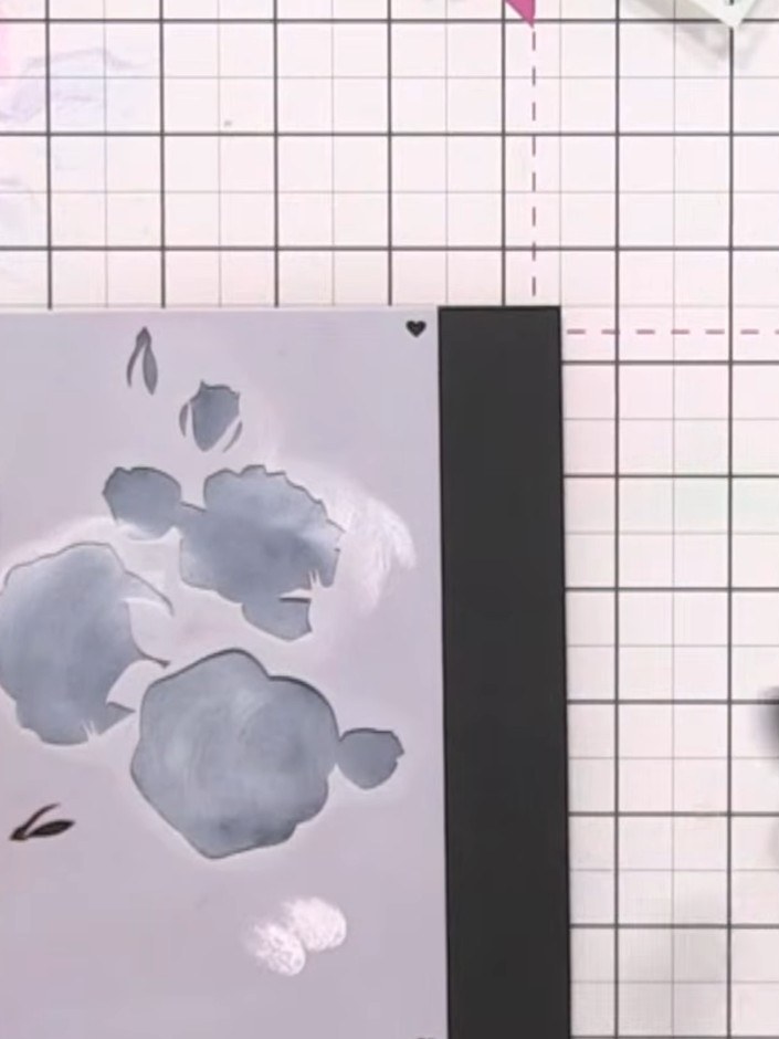 Step 4: Apply stencil number two over your card and ink through with white ink using a blending brush. Build up the wh