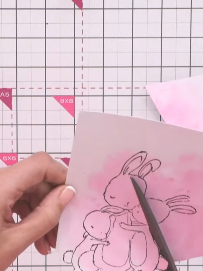 Step 11: Fussy cut around the stamped bunny image carefully using scissors. Work gradually, moving the card rather than