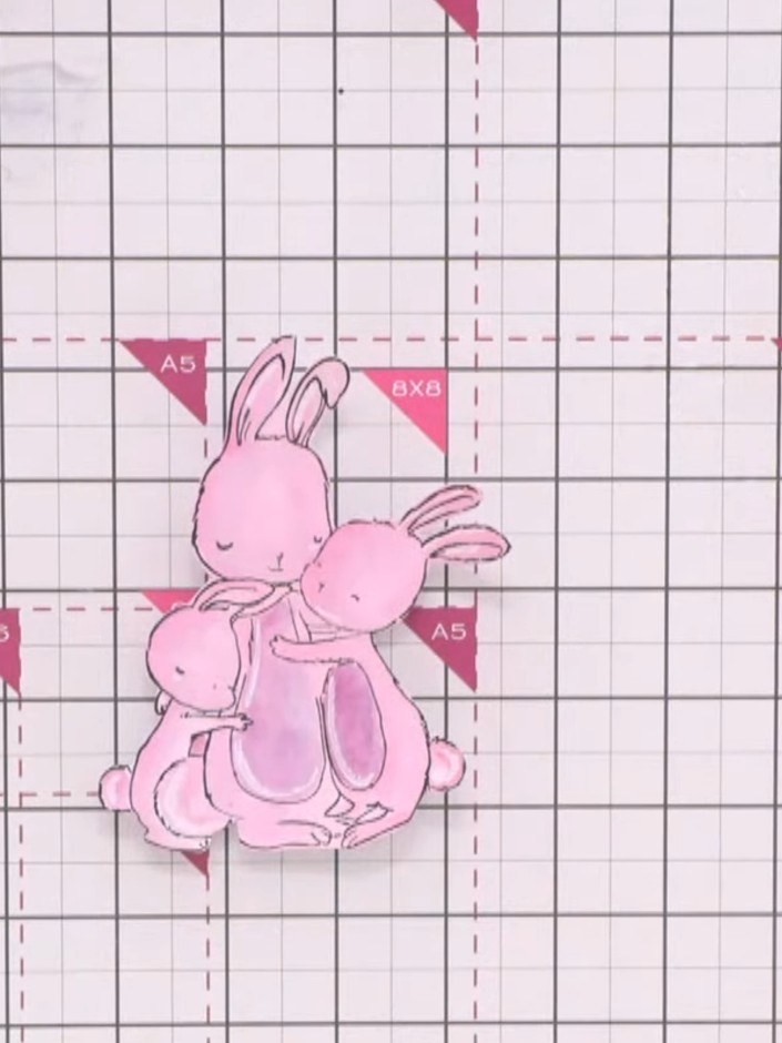 Step 14: Apply adhesive to the back of the pink patterned paper piece and attach it to the white card mat, ensuring it 