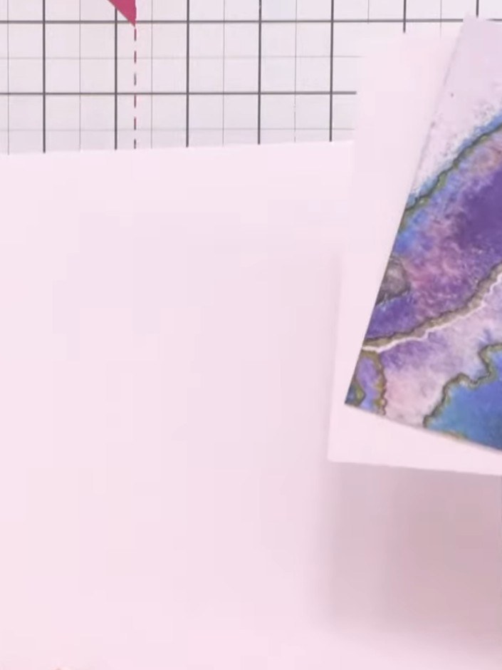 Step 5: Apply a light watercolour wash to the back of the patterned paper piece using water and ink. Use gentle stroke